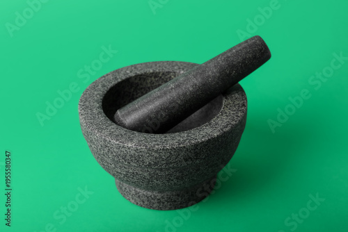 Mortar and pestle on green ...