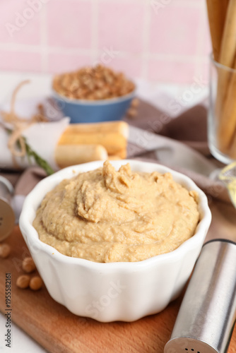 Bowl with tasty hummus on t...