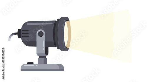 Professional black studio spotlight stands on its base and emits a powerful beam of warm yellow light towards the right.