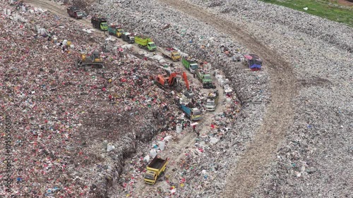 Aerial view of garbage trucks at a landfill environmental pollution site