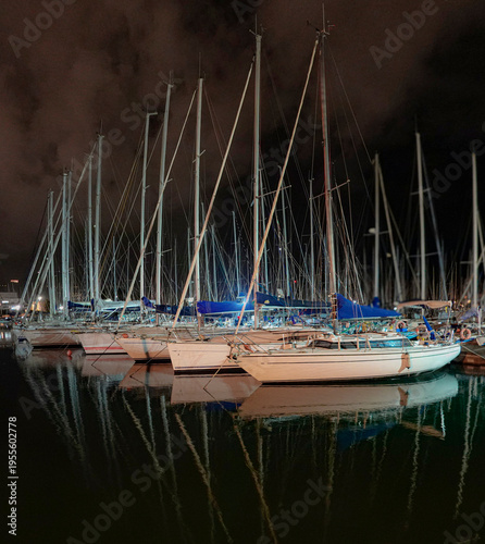 Yachts at harbor at night