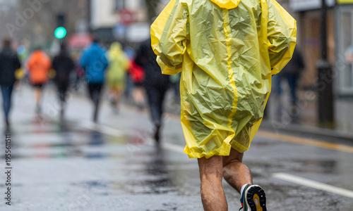 Wallpaper Mural Man running in yellow raincoat on city street during marathon   Torontodigital.ca