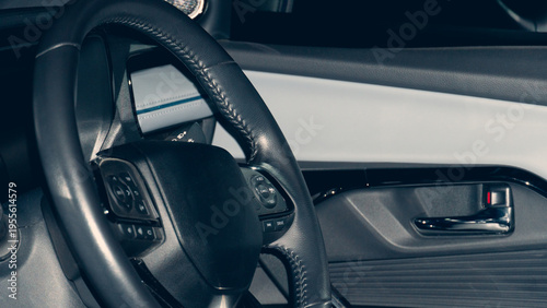 Interior features a multi-function steering wheel and a dark. Aggressive color scheme. Atmosphere is vintage at night.