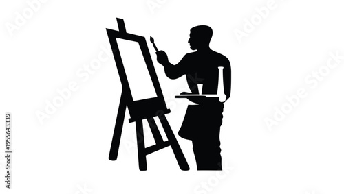 A silhouette of an artist painting on an easel in a studio
