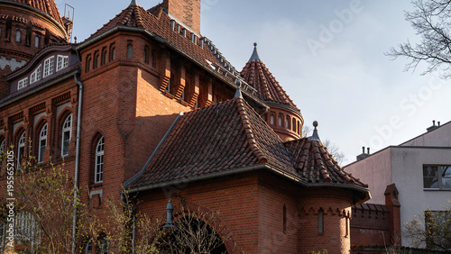 Εκτύπωση καμβά Historic Red Brick Facade with Turrets and Tiled Roofs