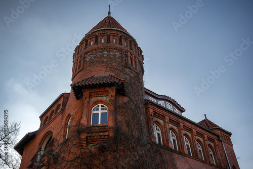 Bilde på lerret Historic Red Brick Tower Against a Blue Sky