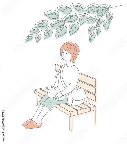 散歩の途中に公園でベンチに腰掛けてひと休みする女性