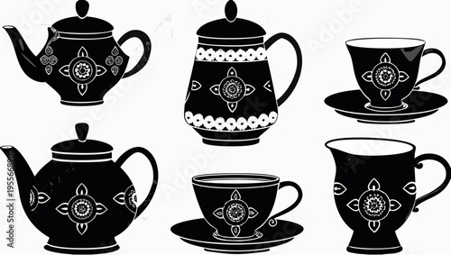A set of black and white tea cups and teapots with floral designs