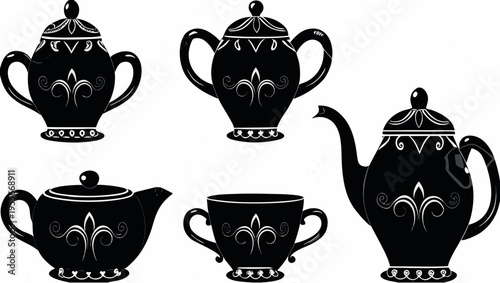 A set of black and white tea cups and teapots with a fleur de lis design