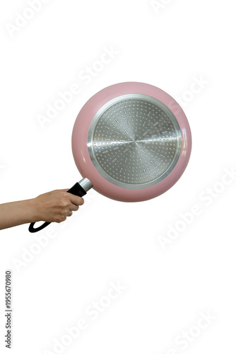 Frying pan in hand on a white background. Isolated object. Hand holds a pink frying pan by the handle, showing the metallic textured bottom surface.