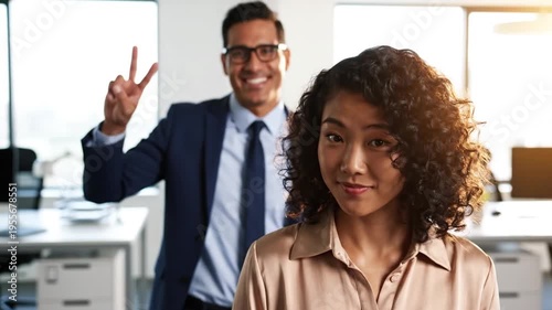 Two colleagues in a modern office setting.