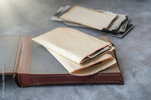 Old black and white photographs in a paper envelope on the table.Archive of family photos.