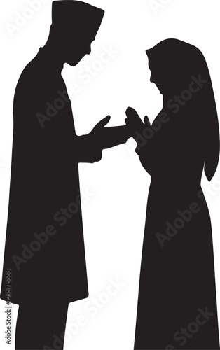 Silhouette of a traditional wedding ring exchange between a couple