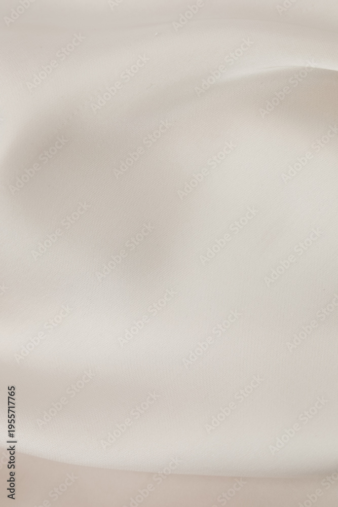 Fototapeta premium Soft fabric in neutral tone on display with gentle folds and smooth surface emphasizing texture and color balance