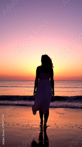 A serene woman walks alone on a beach at sunset, enjoying peaceful ocean views