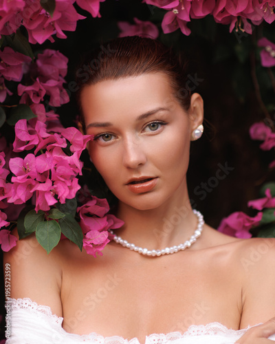 Romantic Woman in Lace With Pearl Jewelry Among Pink Bougainvillea