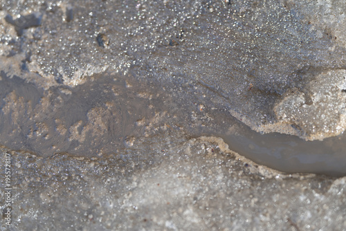 Photography Flowing dirty snow melts along curb