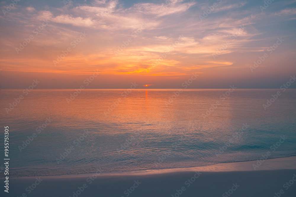 Obraz premium Deep orange sunset over calm ocean horizon, soft gradient sky, serene seascape, peaceful nature background, summer travel atmosphere