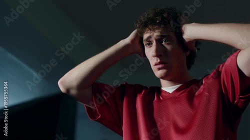 Young man holding his head in distress