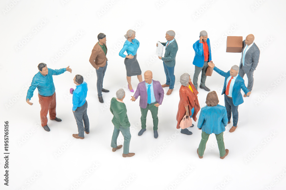 Obraz premium Miniature people talking and interacting in a social gathering setting on a plain background