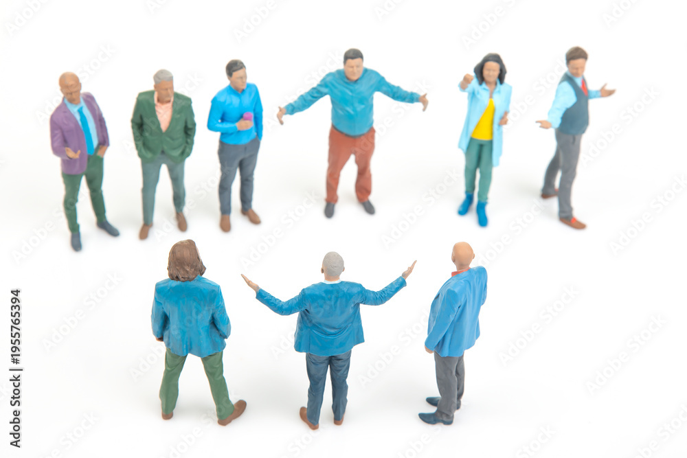 Fototapeta premium Miniature people gather and engage in conversation in a small group setting during daytime with a white background