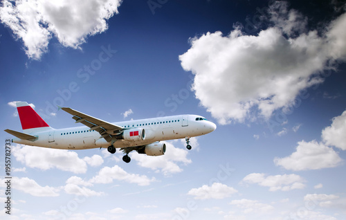 Commercial Airplane Flying in Blue Sky with Clouds, Passenger Aircraft Landing Approach, Aviation Travel Concept, Modern Airliner Transport, Low Angle View with Copy Space