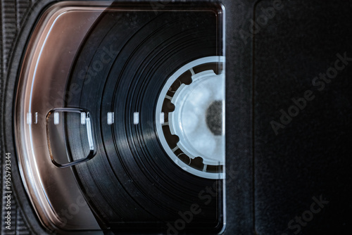 Fotografie Close-up view of a VHS tape showing the black magnetic tape and white spool insi