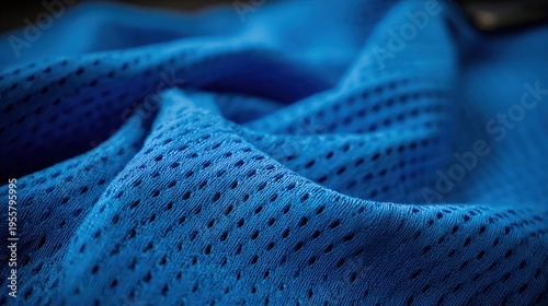 Vibrant blue athletic textile displays a detailed mesh pattern and soft folds