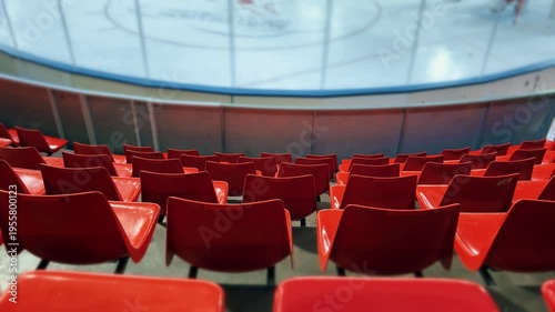 Empty Red Arena Seats Facing Ice Rink During Hockey Training or Match