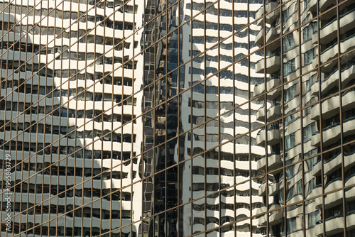 Canada, Alberta, Calgary.  Reflections in the glass of highrise office towers in the financial district.