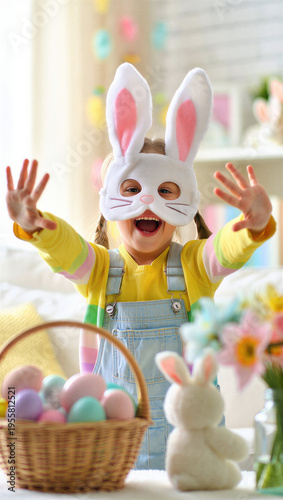 Happy child in bunny mask with arms outstretched, smiling girl in Easter costume near egg basket, spring holiday celebration at home, festive pastel decorations, playful childhood moment