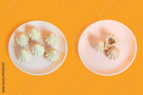 Steamed sweet modak rice dumplings on white plates. Ganesh festival
