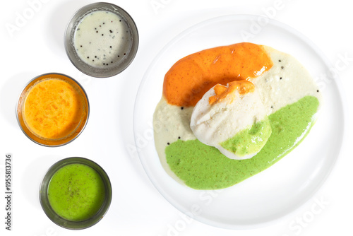 Three varieties of chutney with idli on a white plate, South Indian food