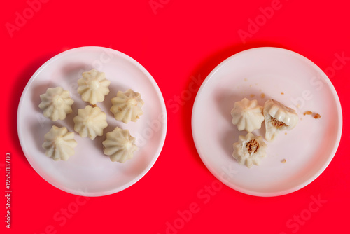 Steamed sweet modak rice dumplings on white plates. Ganesh festival