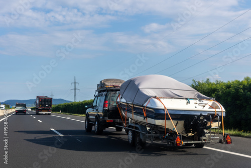 Photos Big luxury cabin motorboat cruiser yacht trailer auto SUV carrier river lake highway road sunset summer light