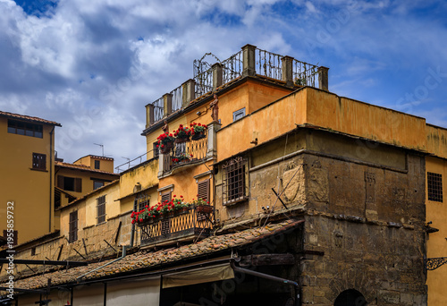 Weathered medieval stone buildings of Ponte Vecchio stand in Florence, Italy