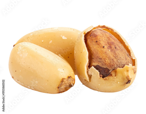 Close-up view of three light-colored, oval-shaped nuts, one partially shelled