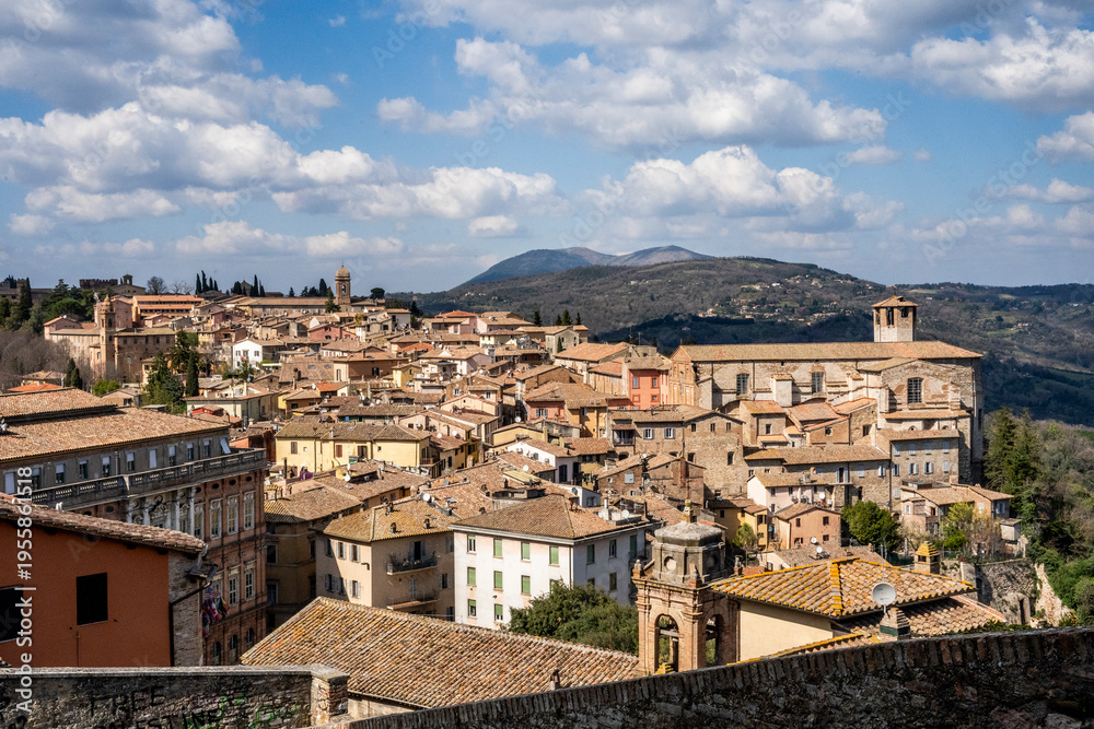 Naklejka premium Panoramic view from the Porta Sole viewpoint over Palazzo Gallenga Stuart (University for Foreigners), the medieval Borgo Sant'Angelo and the surrounding Umbrian hills, Perugia, Umbria, Italy.