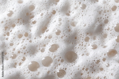 Close-up of Frothy Liquid with Bubbles and Light Reflections.