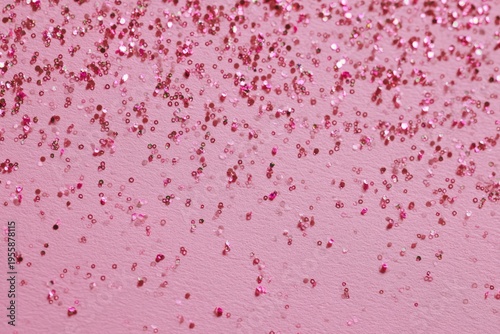 Pink confetti background with sparkling glitter for festive occasions.