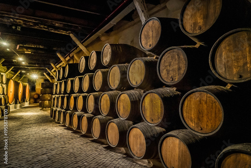 Fotografía Wine cellar, row of wooden barrels