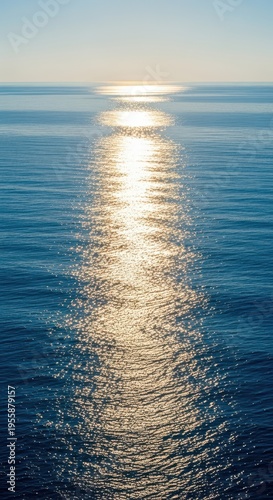 A brilliant beam of sunlight creates a shimmering, defined pathway across the vast blue surface of the deep ocean waters toward the horizon line, track, Pathway, horizon