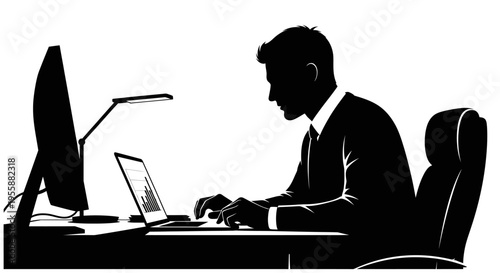 Silhouette of a man working on a laptop and computer at a desk in a modern office