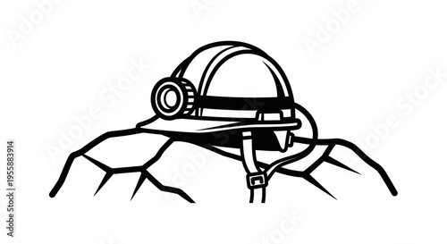 Mining helmet with headlamp on rock.