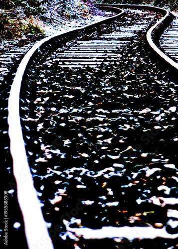 A view of a curved railway track covered in snow.