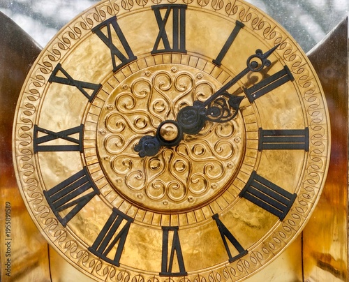 Photograph capturing fine craftsmanship and decorative features of historic brass clock face