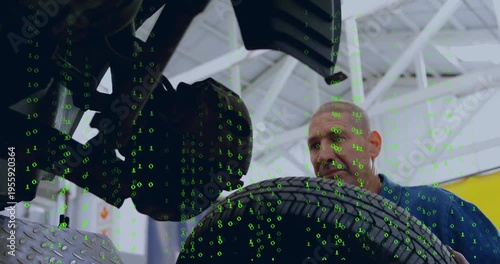 Mechanic after lift reaching, seating tire on hub for auto repair green binary overlay hiding hub