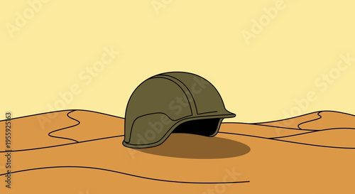 A military helmet on sandy ground.