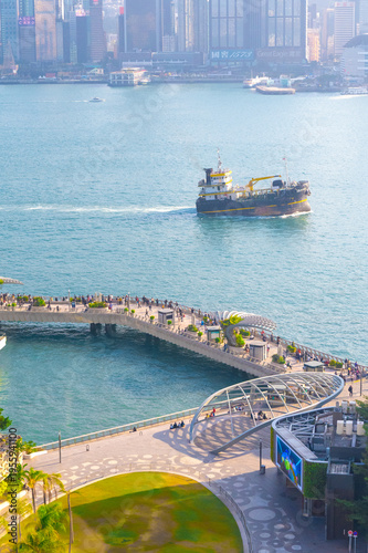 Obraz na płótnie Daytime view of Victoria Harbour waterfront promenade in Hong Kong with a cargo