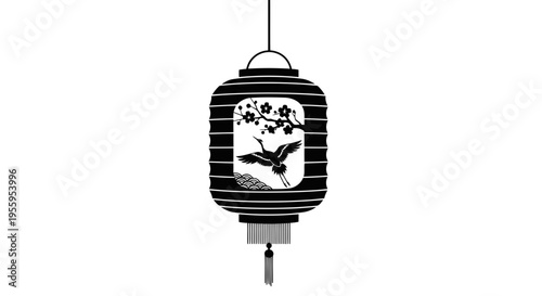 A black and white lantern with a bird design hanging from a cord.